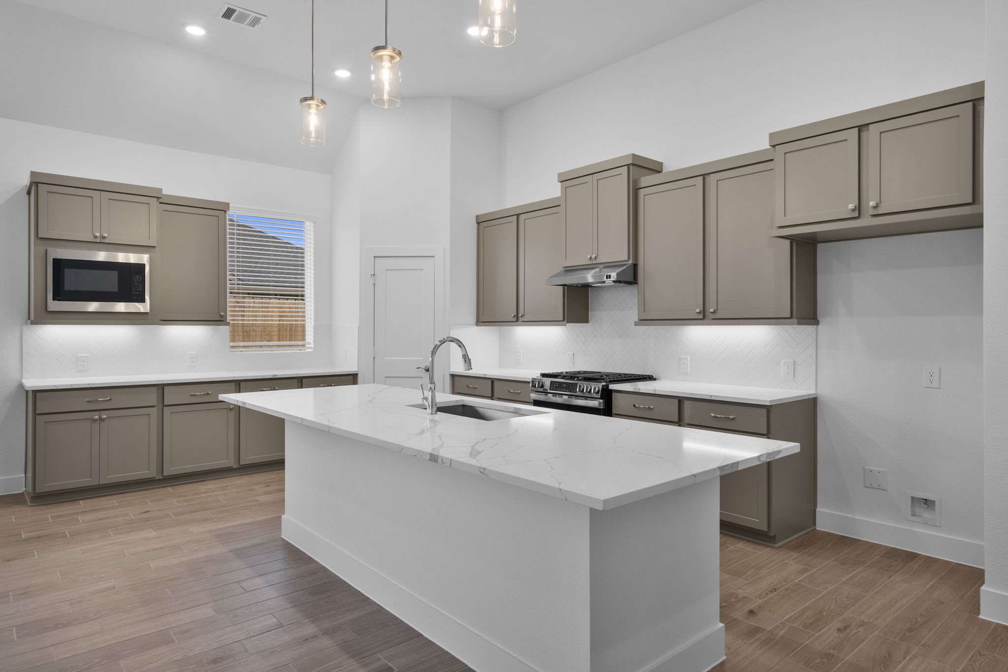 337 Gambels Quail Road Waller, TX 77484 - Photo 5 of 35 a kitchen with stainless steel appliances granite countertop a sink stove and refrigerator