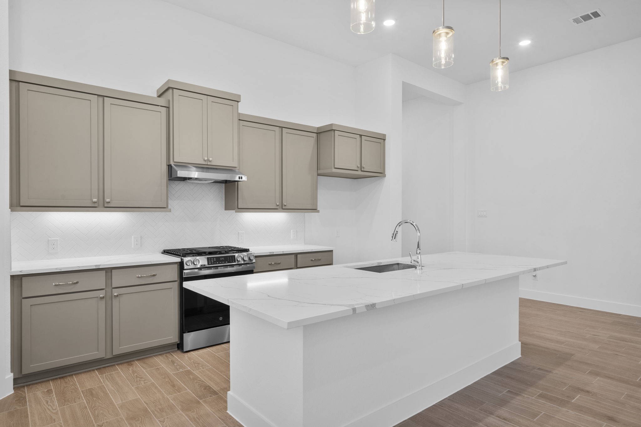 337 Gambels Quail Road Waller, TX 77484 - Photo 7 of 35 a kitchen with stainless steel appliances granite countertop a sink stove and cabinets