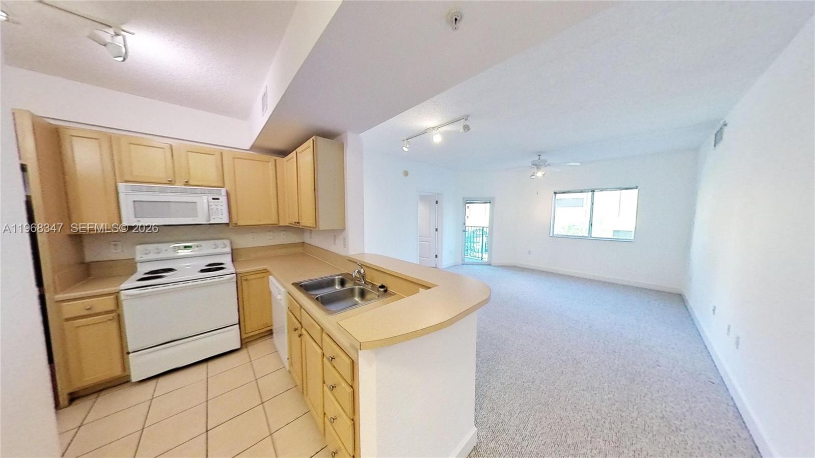 a kitchen with cabinets appliances a sink and a window