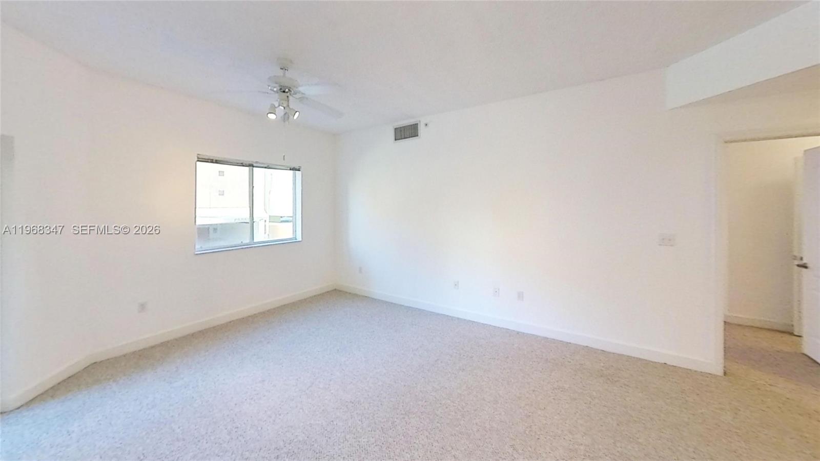 6001 Southwest 70th Street, Unit 217 South Miami, FL 33143 - Photo 11 of 21 an empty room with a chandelier fan