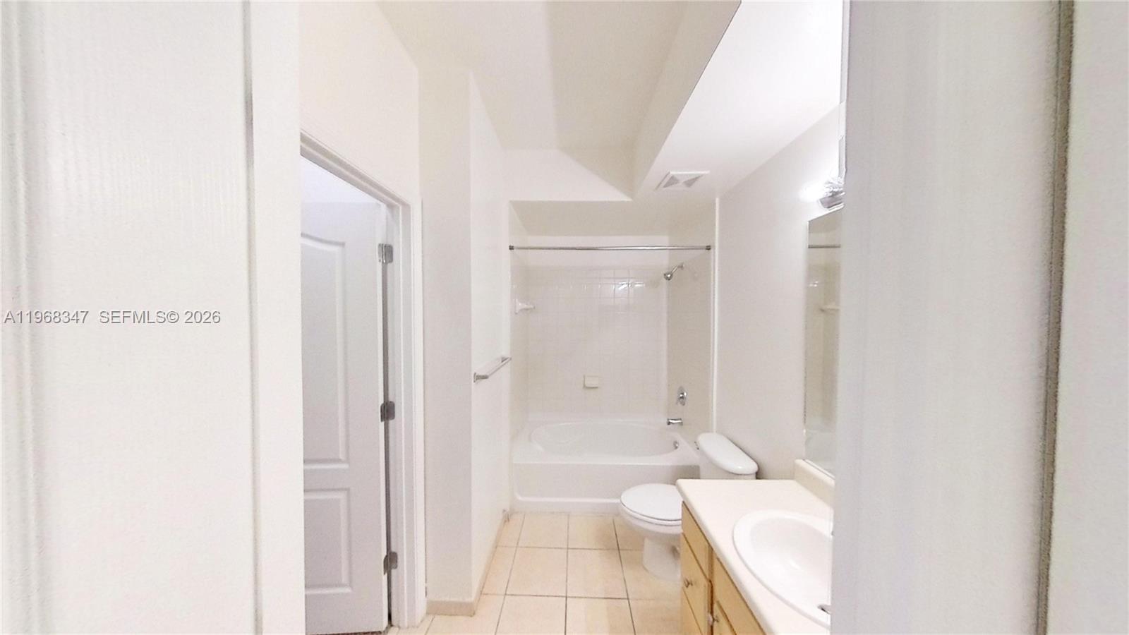 6001 Southwest 70th Street, Unit 217 South Miami, FL 33143 - Photo 9 of 21 a bathroom with a tub shower and sink