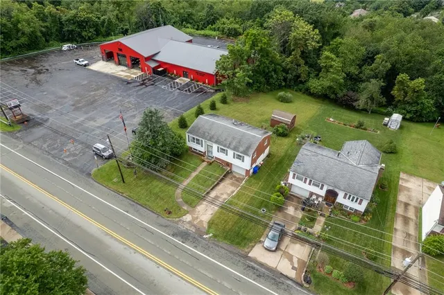 an aerial view of a house with a yard and garden