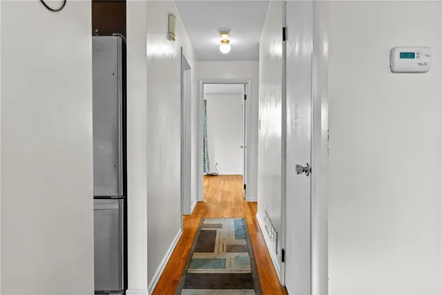 a view of gallery with wooden floor