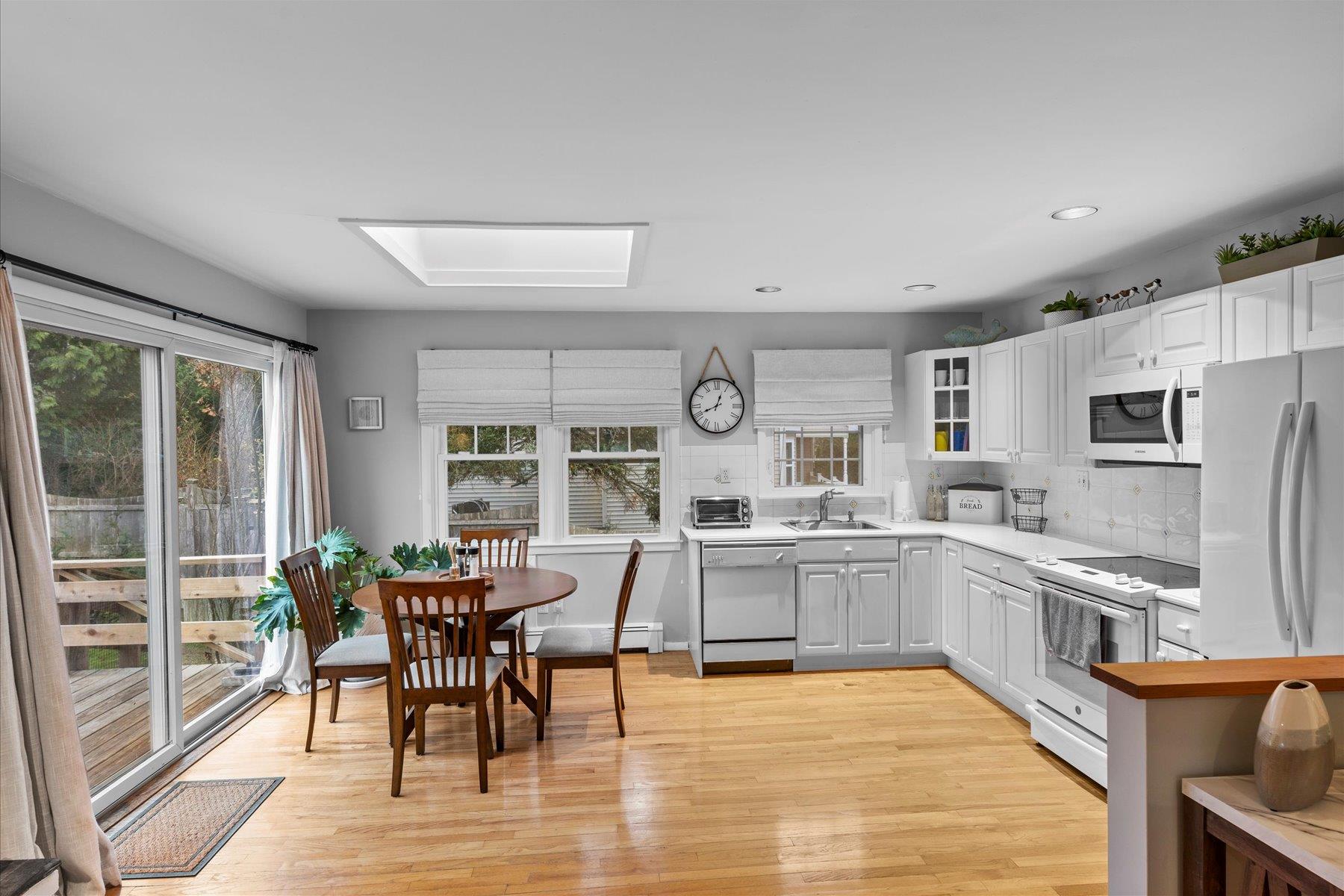 3 Crestview Drive Remsenburg, NY 11960 - Photo 5 of 21 Kitchen featuring decorative backsplash, light countertops, white appliances, and a sink