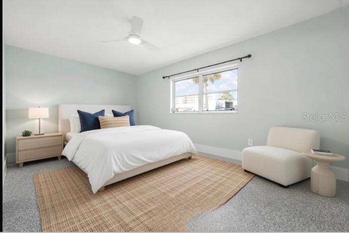 5830 Midnight Pass Road, Unit 94 Sarasota, FL 34242 - Photo 15 of 36 a bedroom with a bed and a couch