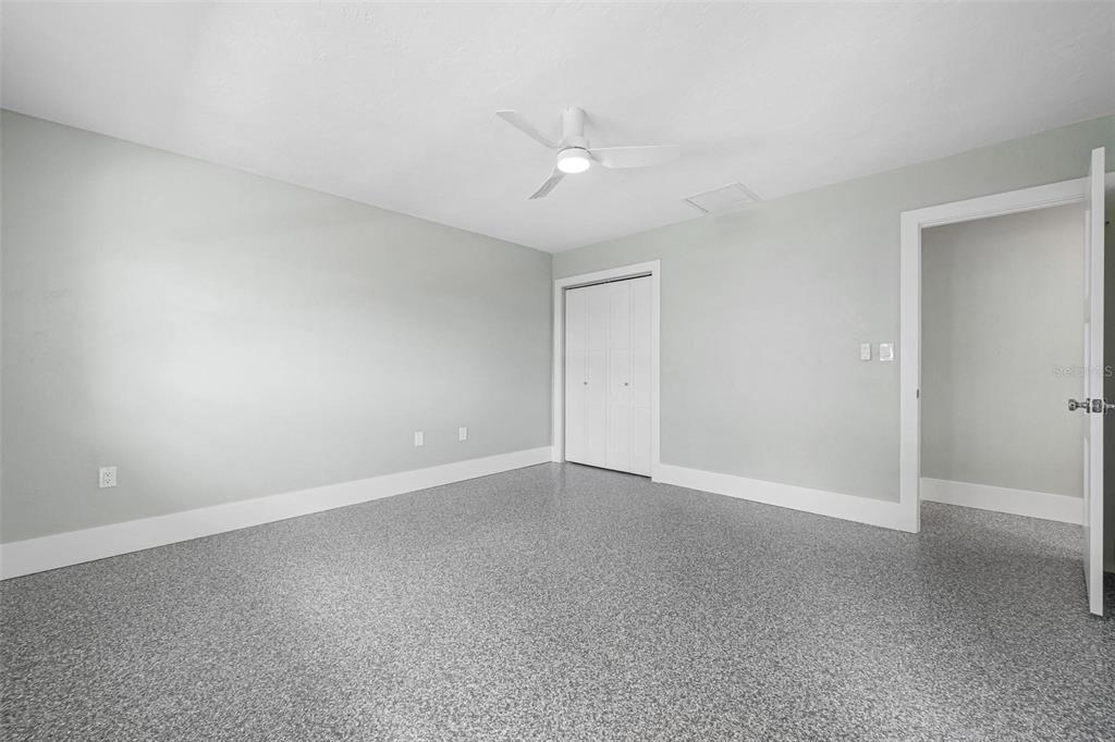 5830 Midnight Pass Road, Unit 94 Sarasota, FL 34242 - Photo 16 of 36 a view of an empty room with a ceiling fan