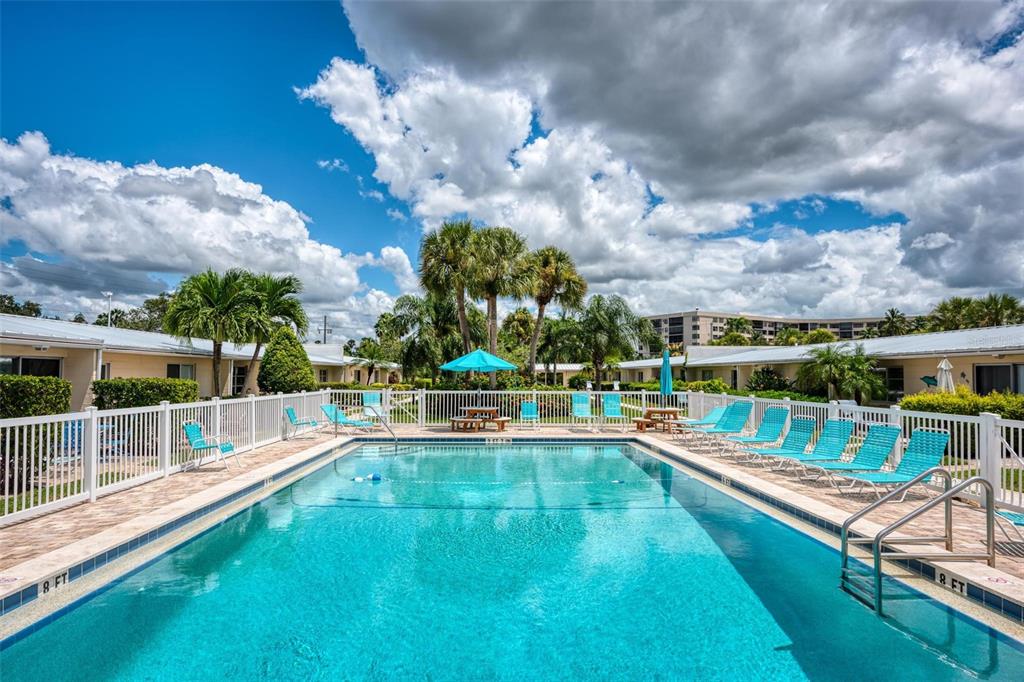 5830 Midnight Pass Road, Unit 94 Sarasota, FL 34242 - Photo 21 of 36 a view of a house with swimming pool and sitting area