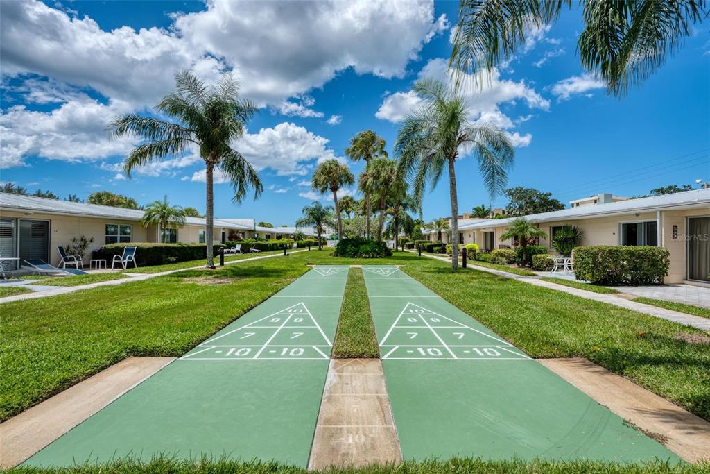 5830 Midnight Pass Road, Unit 94 Sarasota, FL 34242 - Photo 23 of 36 a view of a house with a yard