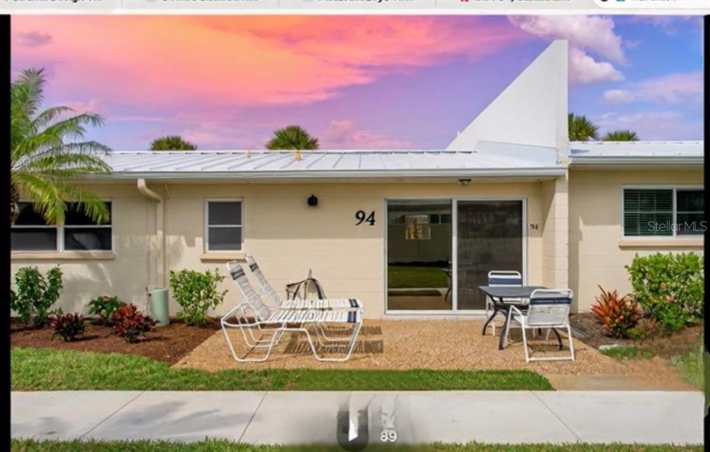 5830 Midnight Pass Road, Unit 94 Sarasota, FL 34242 - Photo 26 of 36 a house view with a sitting space and garden space