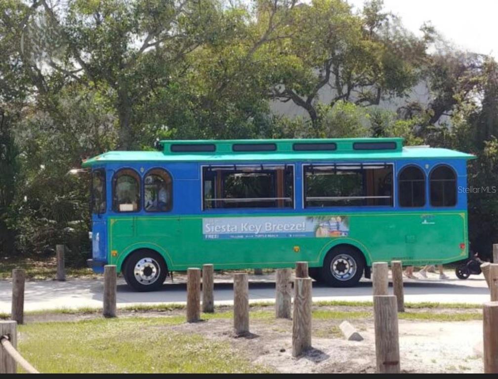 5830 Midnight Pass Road, Unit 94 Sarasota, FL 34242 - Photo 30 of 36 a front view of a house with swimming pool and yard