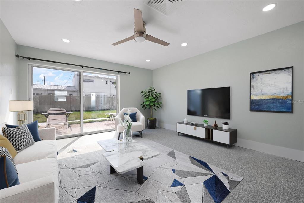 5830 Midnight Pass Road, Unit 94 Sarasota, FL 34242 - Photo 3 of 36 a living room with furniture a flat screen tv and a large window