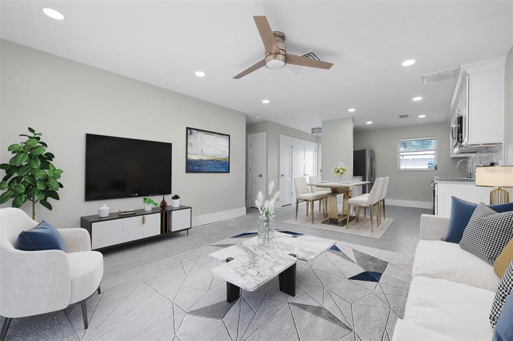 5830 Midnight Pass Road, Unit 94 Sarasota, FL 34242 - Photo 4 of 36 a living room with furniture and a flat screen tv