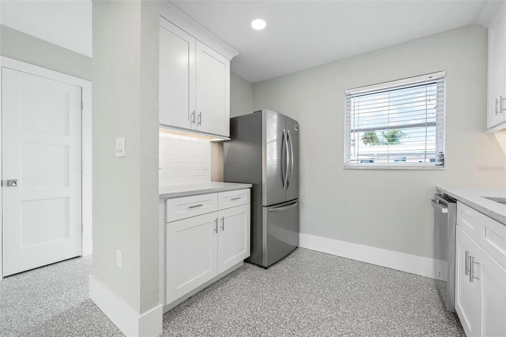 5830 Midnight Pass Road, Unit 94 Sarasota, FL 34242 - Photo 7 of 36 a kitchen with stainless steel appliances a refrigerator sink and cabinets