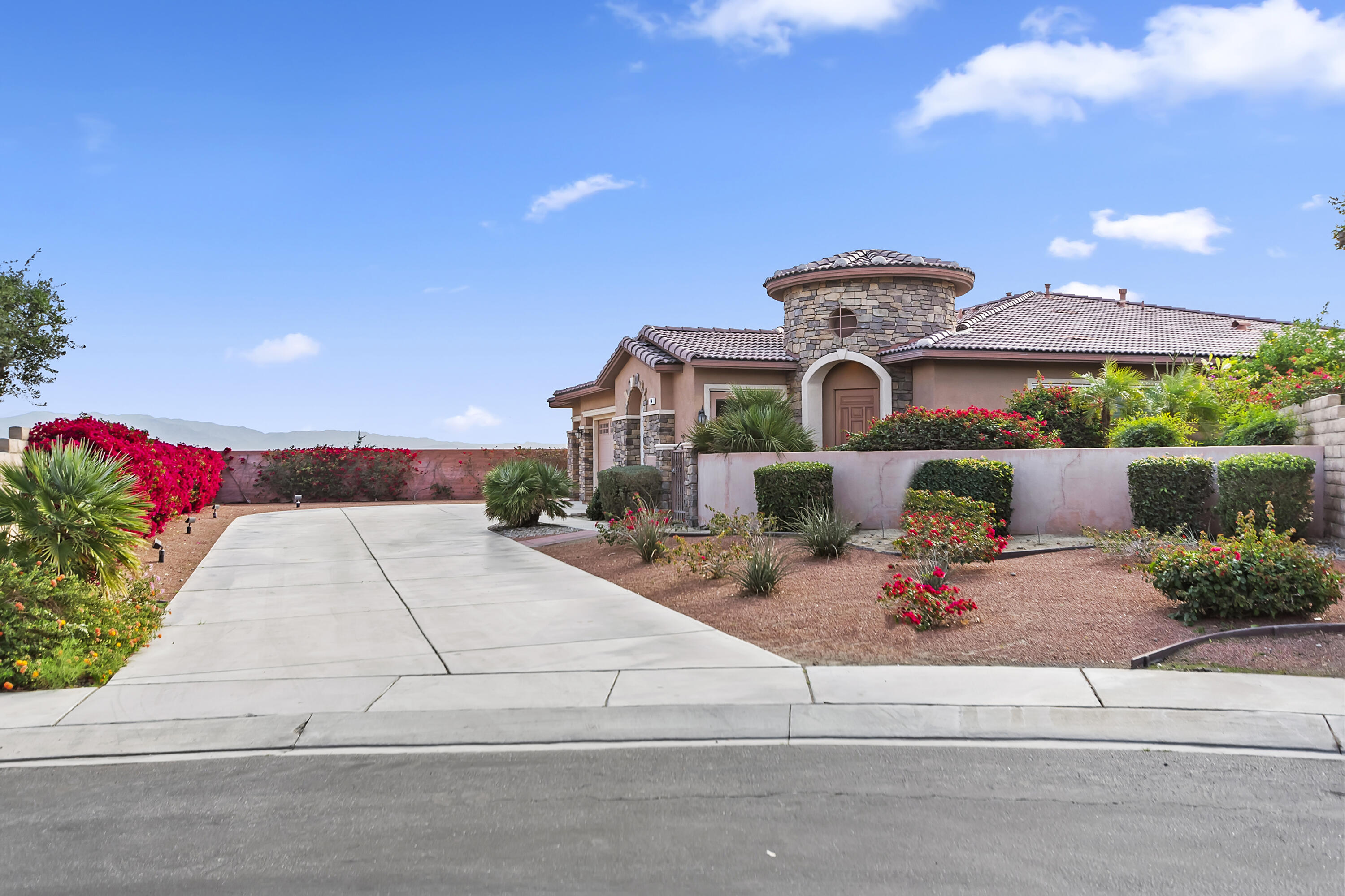134 Via Tuscany Rancho Mirage, CA 92270 - Photo 1 of 44 a front view of a house with a yard and garage