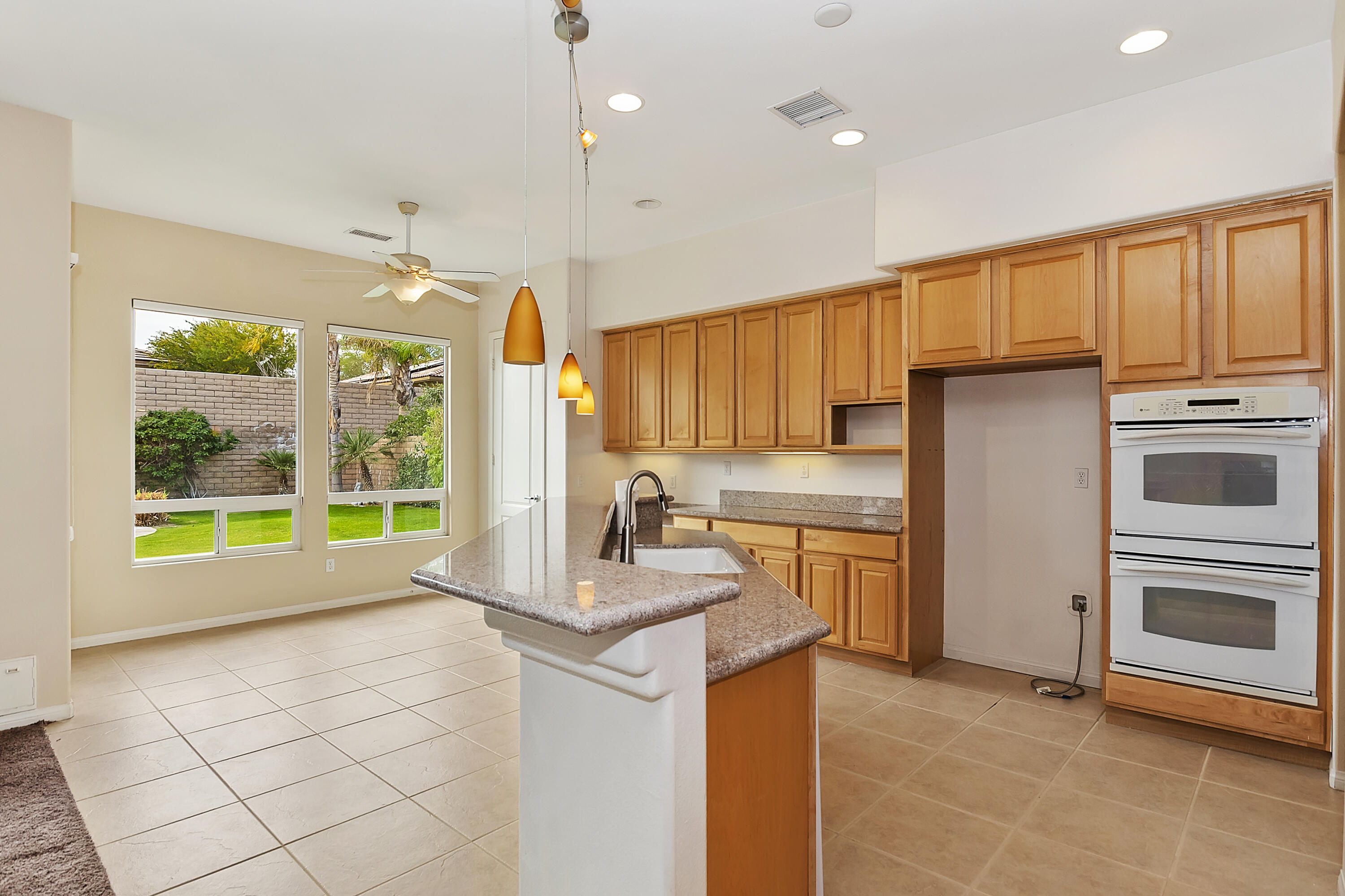 134 Via Tuscany Rancho Mirage, CA 92270 - Photo 11 of 44 a kitchen with a stove a sink and a refrigerator