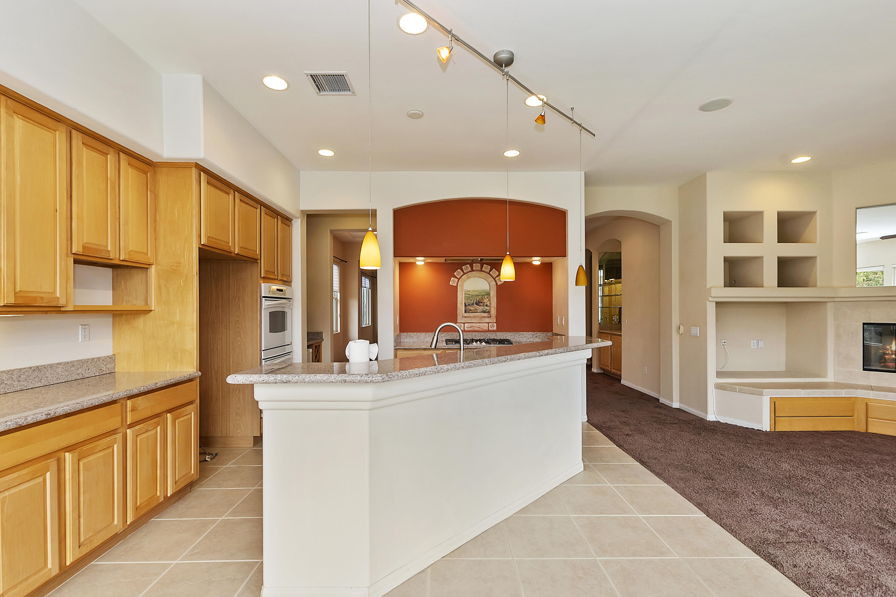 134 Via Tuscany Rancho Mirage, CA 92270 - Photo 13 of 44 a large kitchen with kitchen island a large counter top stainless steel appliances and cabinets
