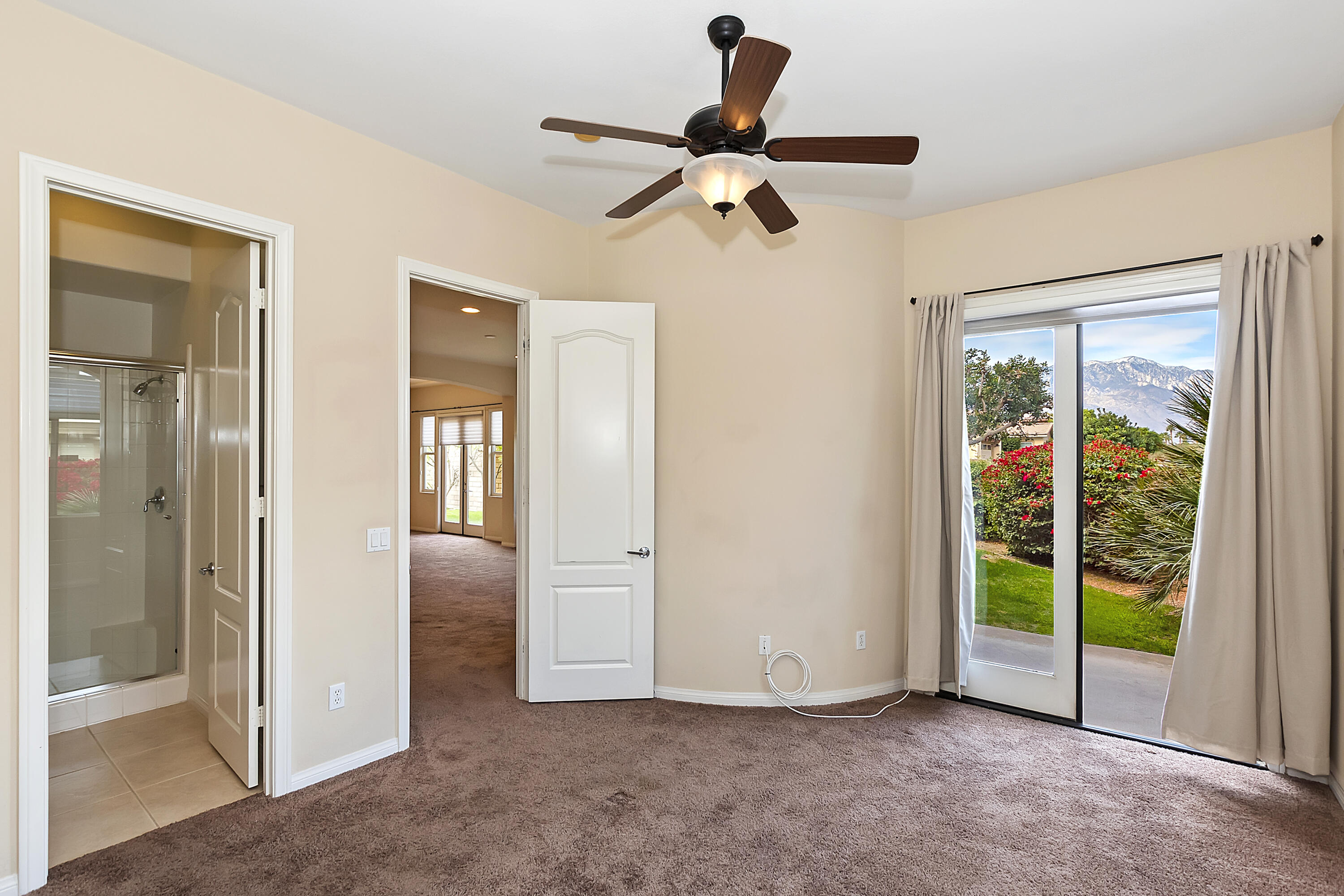 134 Via Tuscany Rancho Mirage, CA 92270 - Photo 18 of 44 an empty room with closet and a chandelier fan