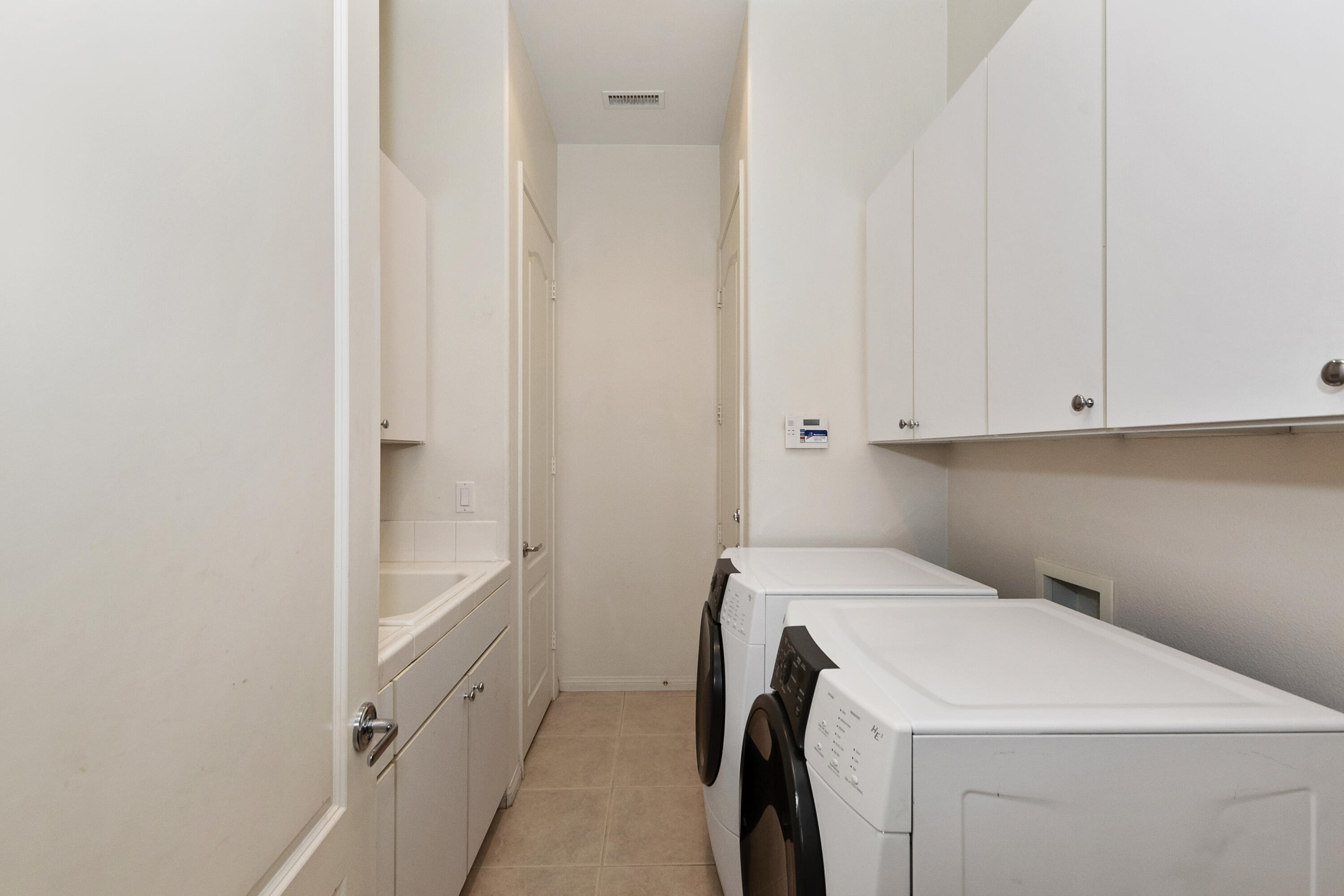 134 Via Tuscany Rancho Mirage, CA 92270 - Photo 21 of 44 a utility room with dryer and washer