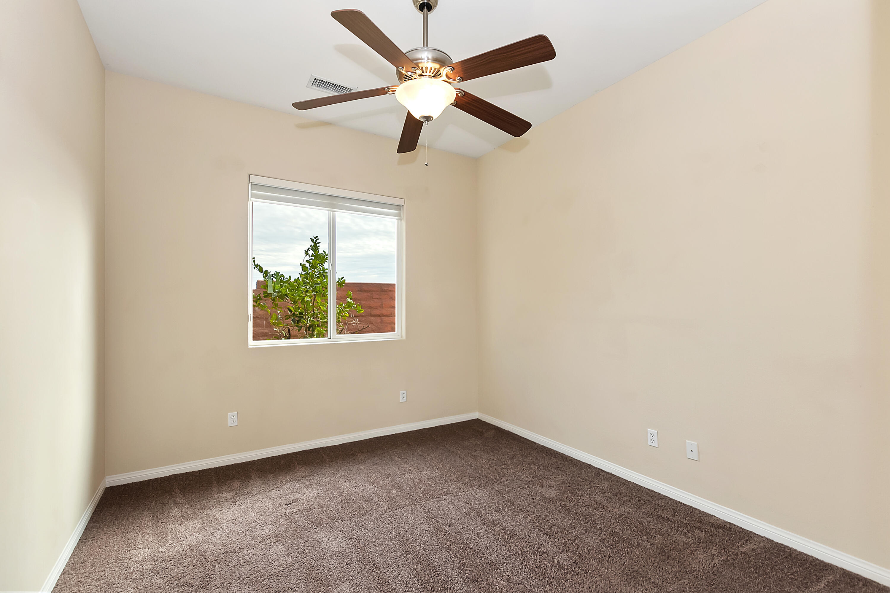 134 Via Tuscany Rancho Mirage, CA 92270 - Photo 22 of 44 an empty room with a window and a fan