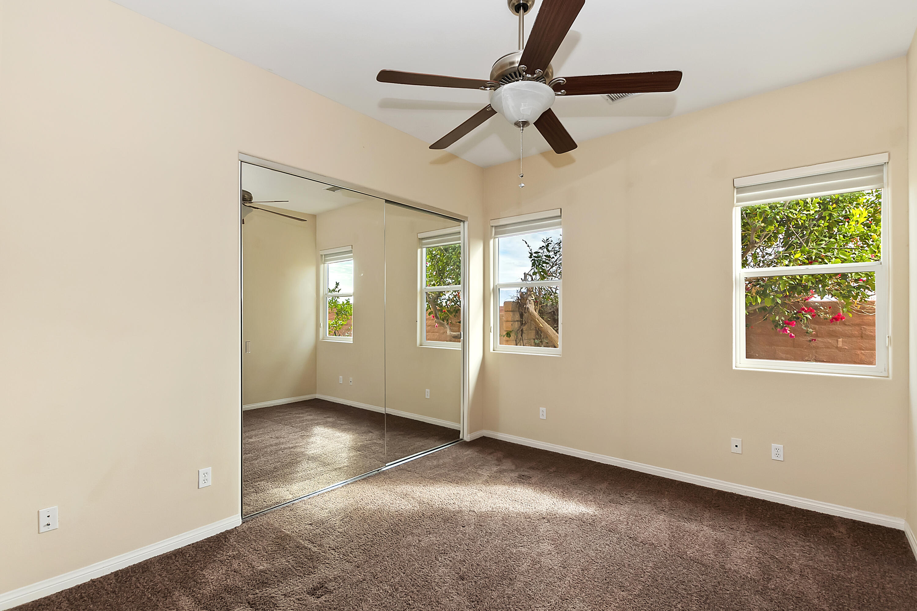 134 Via Tuscany Rancho Mirage, CA 92270 - Photo 25 of 44 an empty room with ceiling fan and windows
