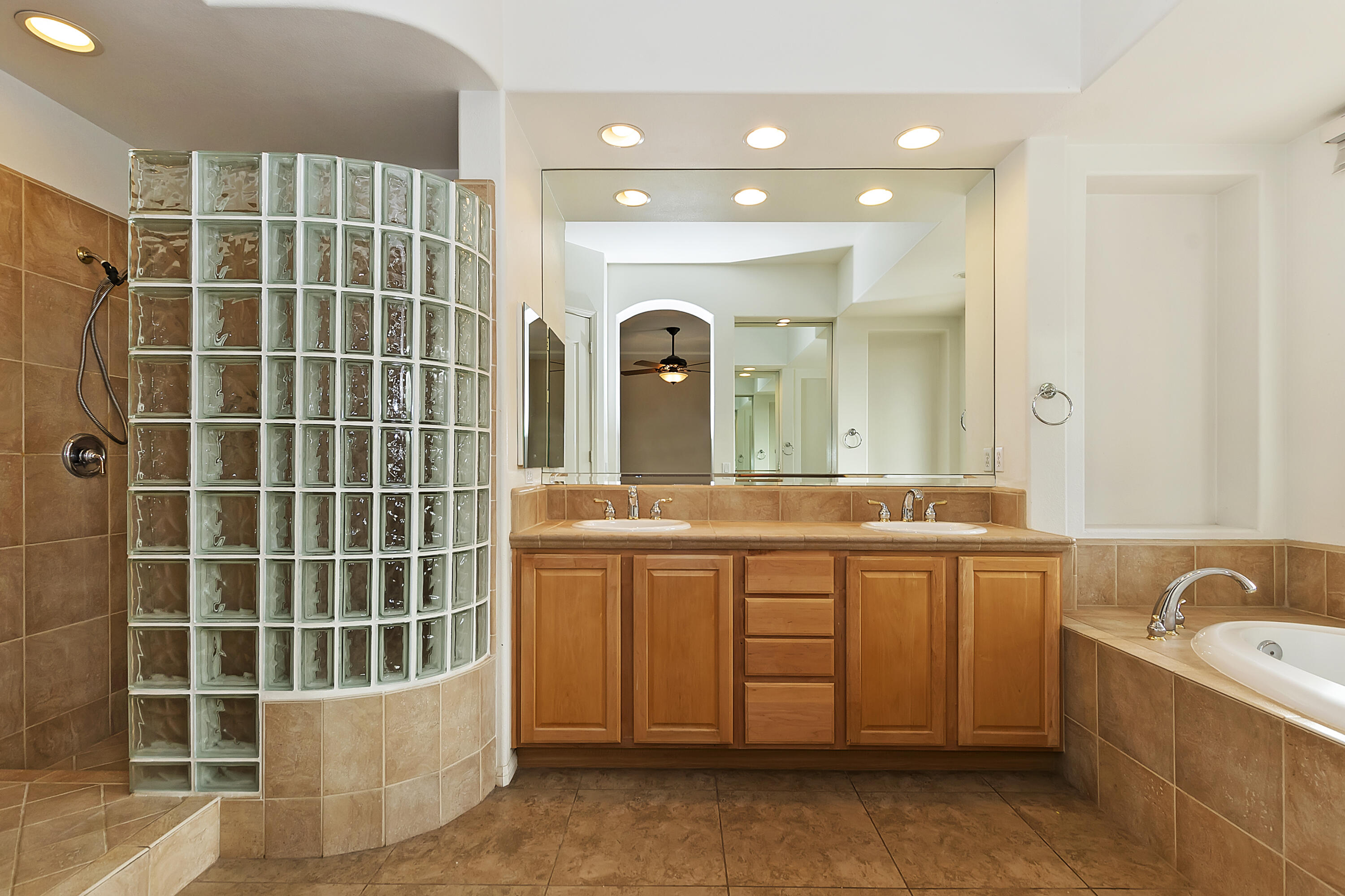 134 Via Tuscany Rancho Mirage, CA 92270 - Photo 30 of 44 a bathroom with a double vanity sink a mirror and a bathtub