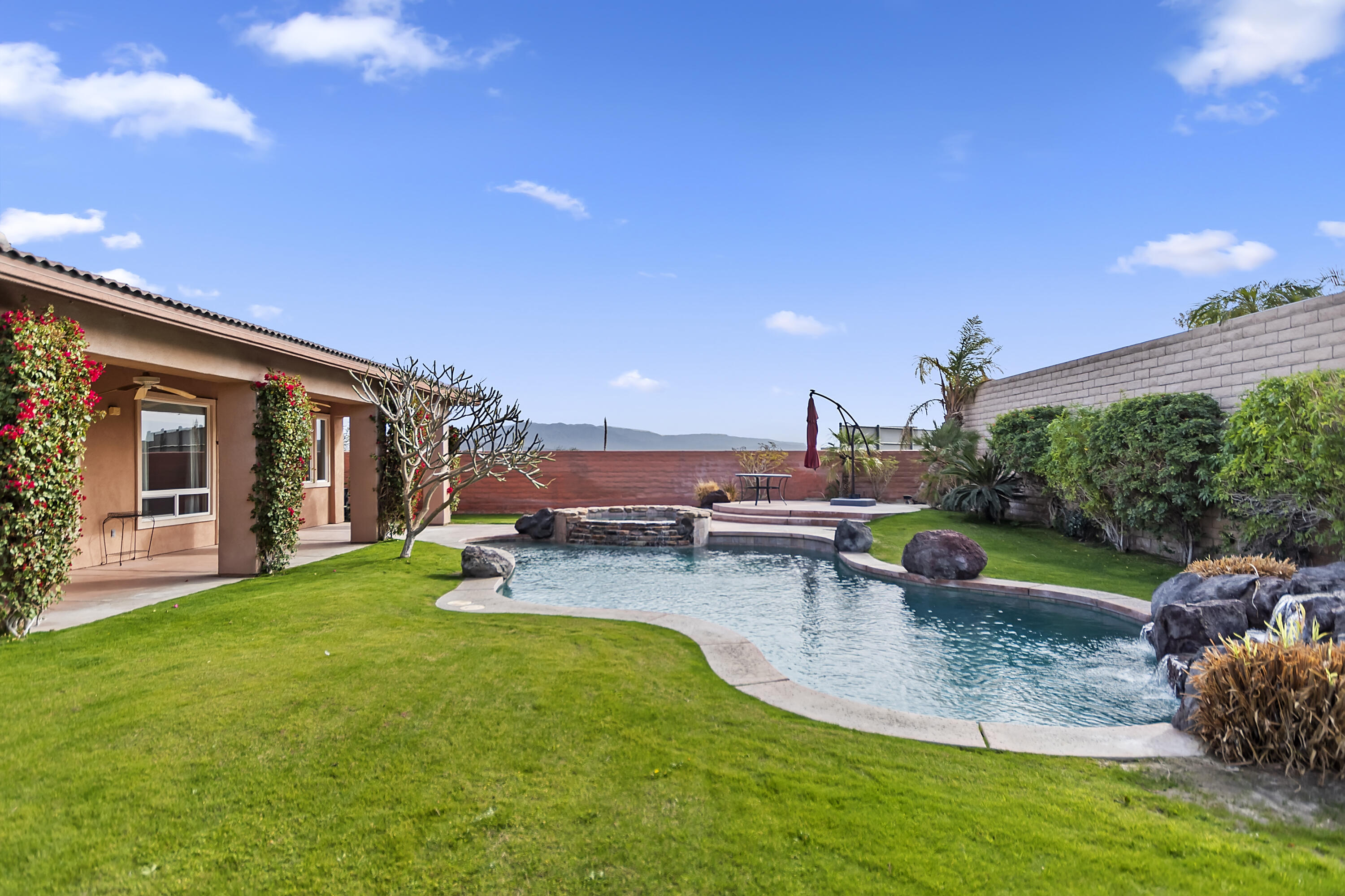 134 Via Tuscany Rancho Mirage, CA 92270 - Photo 36 of 44 a view of a house with swimming pool and a yard