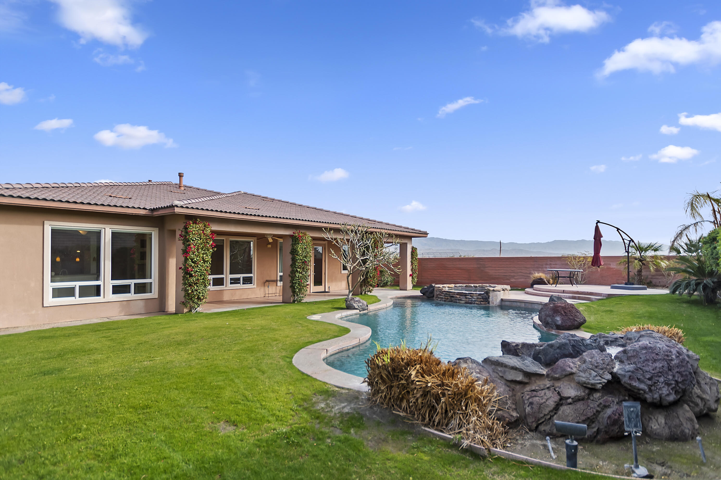 134 Via Tuscany Rancho Mirage, CA 92270 - Photo 37 of 44 a view of a house with swimming pool and a yard