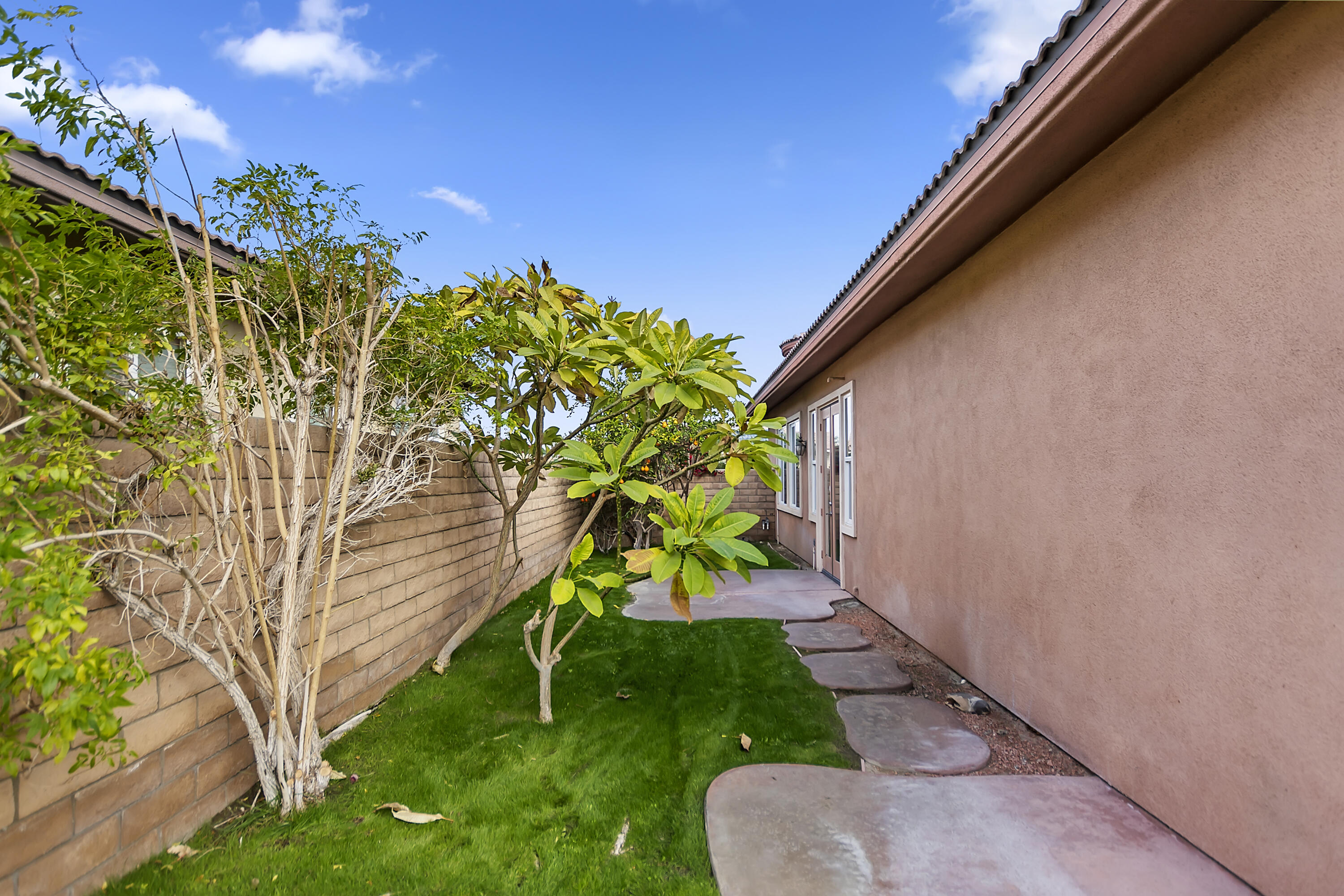 134 Via Tuscany Rancho Mirage, CA 92270 - Photo 38 of 44 a view of a yard with plants and a fountain