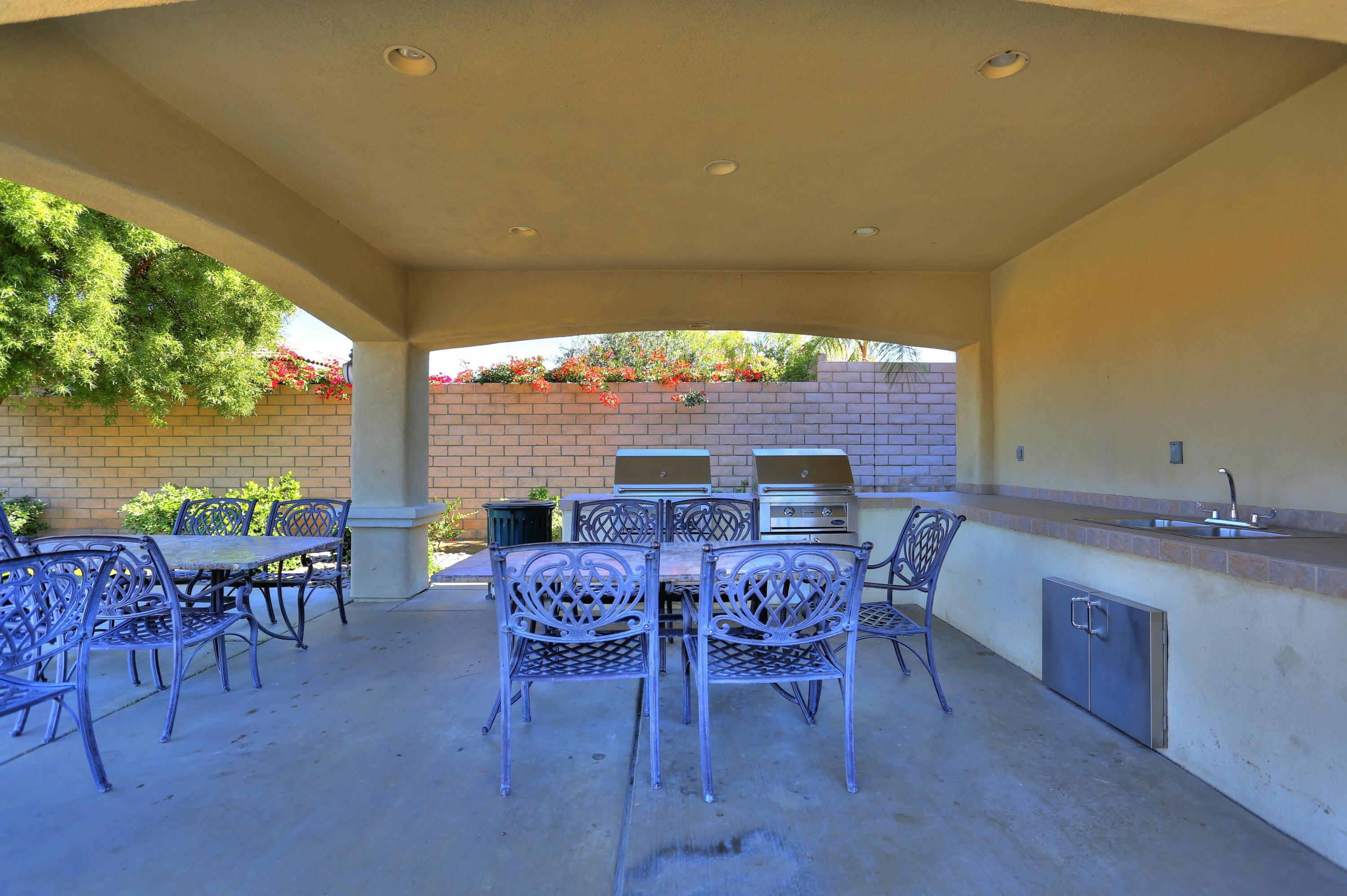 134 Via Tuscany Rancho Mirage, CA 92270 - Photo 42 of 44 a view of a patio with table and chairs