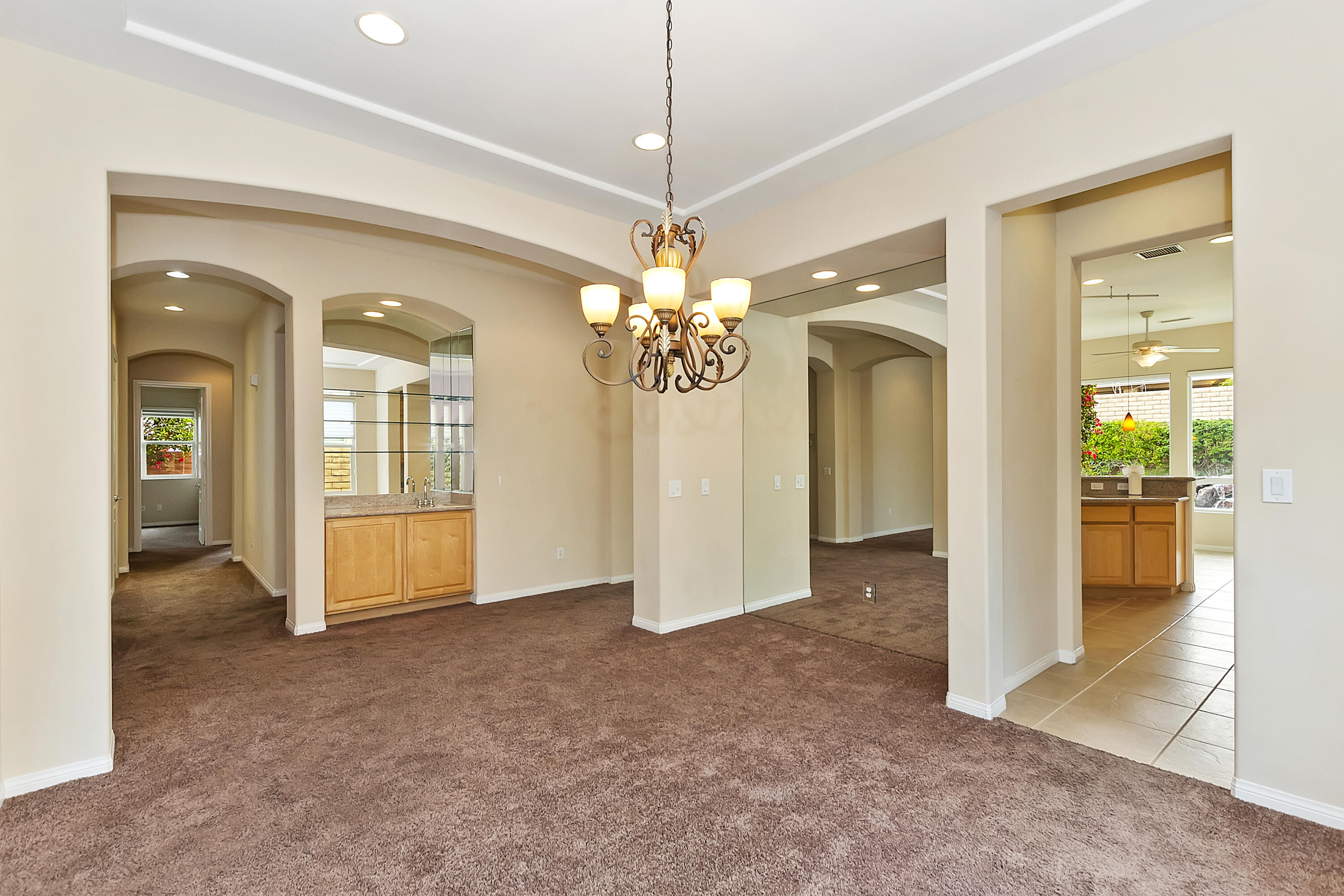 134 Via Tuscany Rancho Mirage, CA 92270 - Photo 6 of 44 a view of a livingroom with a chandelier fan and windows