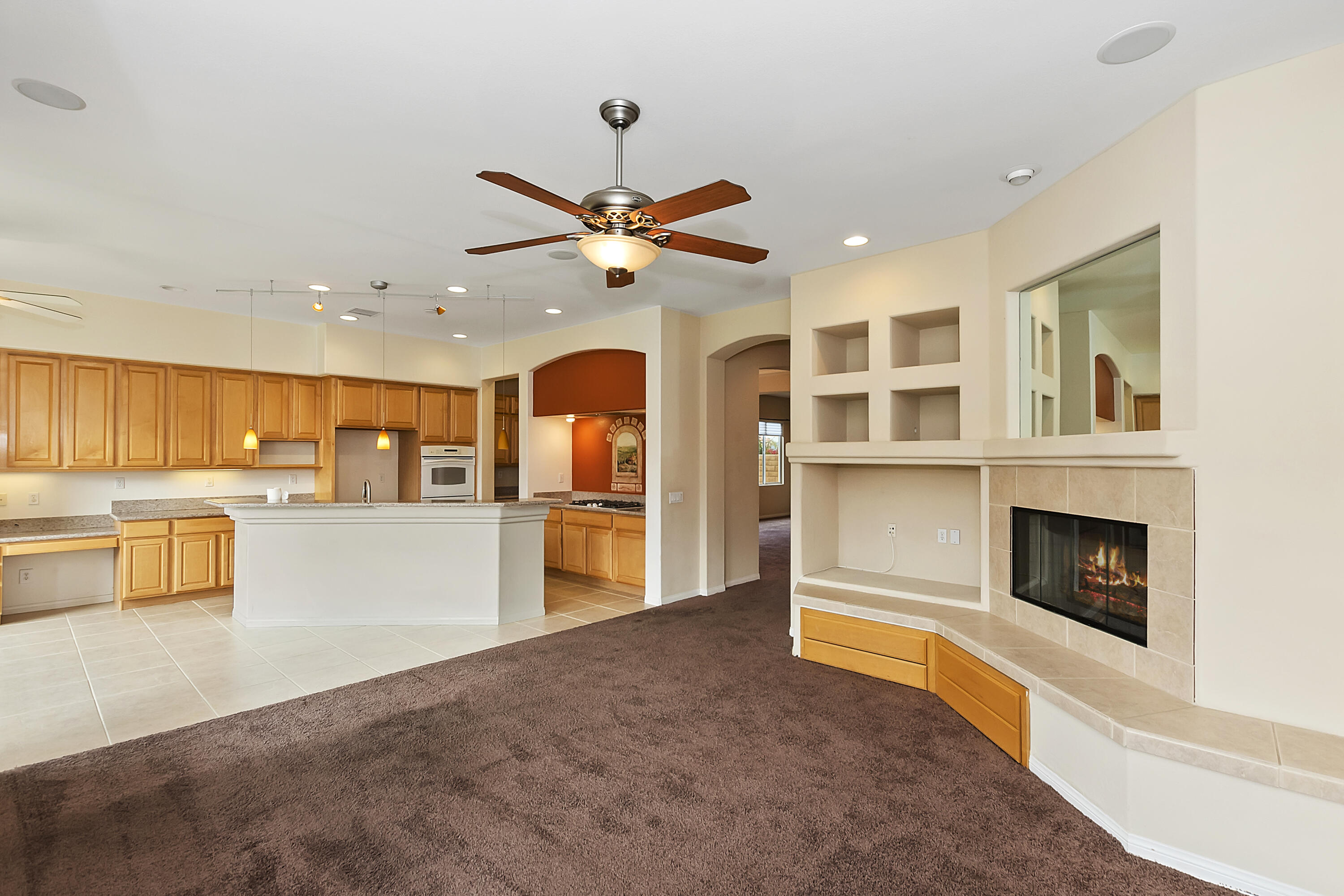 134 Via Tuscany Rancho Mirage, CA 92270 - Photo 10 of 44 a view of a kitchen with a sink and a fireplace
