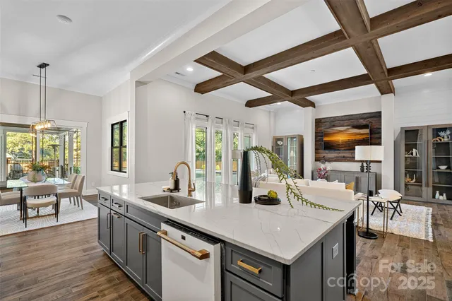 a view of a kitchen counter top space with furniture wooden floor and windows