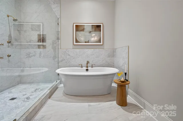 a white bath tub sitting next to a shower