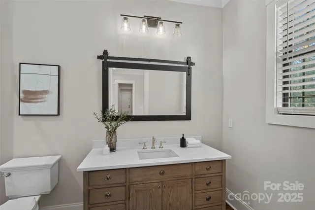 a bathroom with a toilet sink and mirror