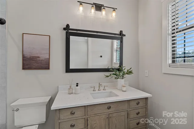 a bathroom with a toilet sink and mirror
