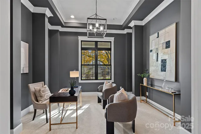 a living room with furniture and a chandelier