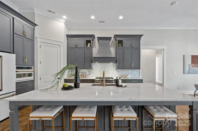a kitchen with cabinets and chairs