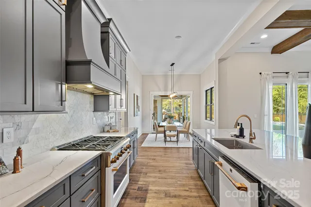 a kitchen with sink stove and cabinets