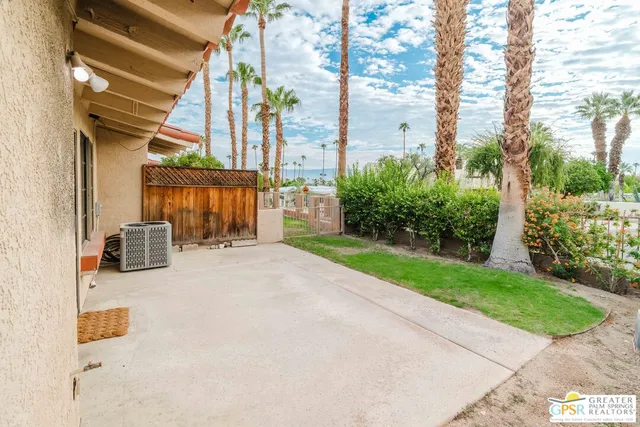 a view of a chair with a table and chairs in patio