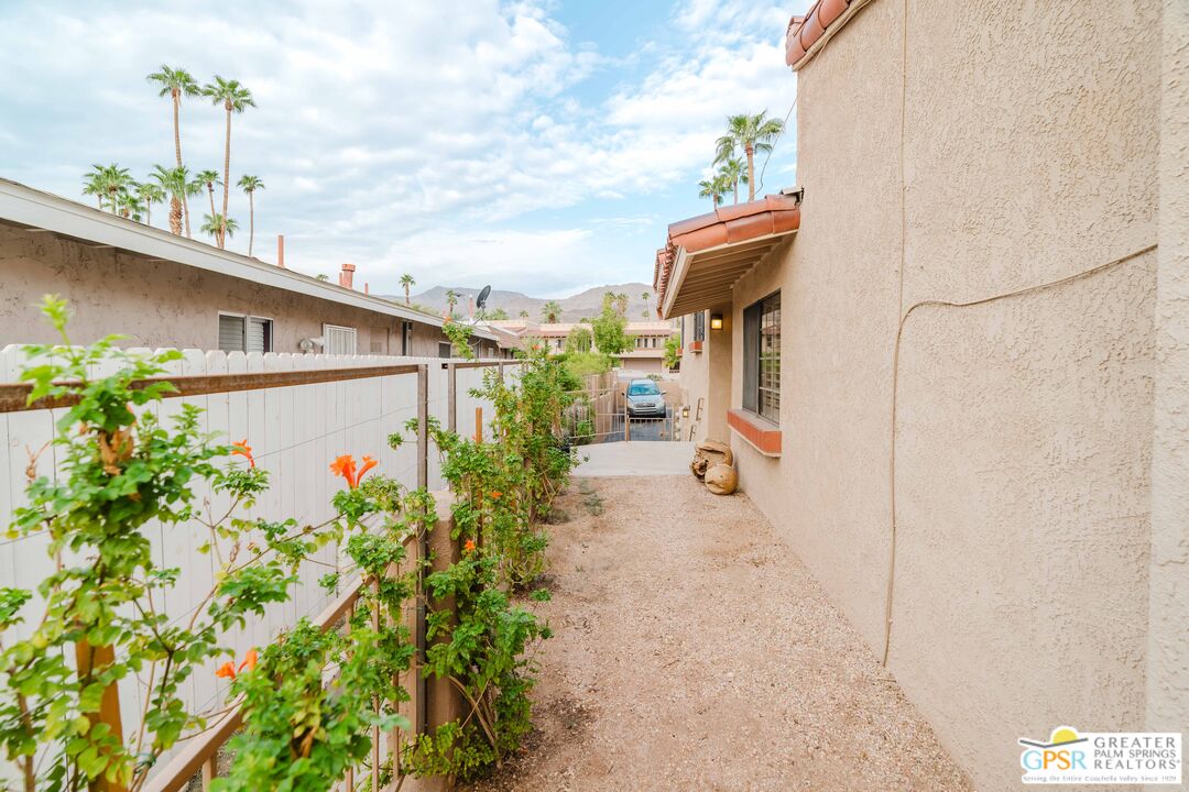 46400 Ryway Place, Unit 10 Palm Desert, CA 92260 - Photo 16 of 48 a front view of a house with a yard and fountain
