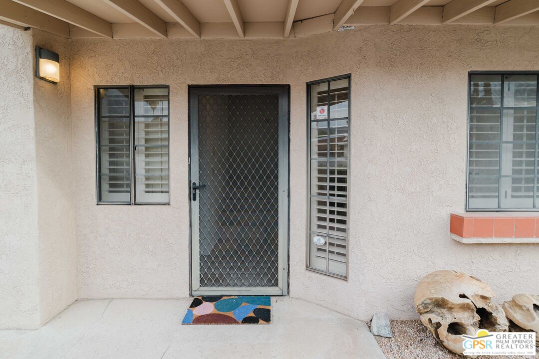 46400 Ryway Place, Unit 10 Palm Desert, CA 92260 - Photo 17 of 48 a living room with furniture and a window