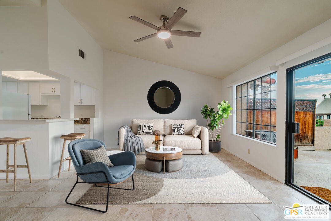 46400 Ryway Place, Unit 10 Palm Desert, CA 92260 - Photo 2 of 48 a living room with furniture a rug potted plant and a large window