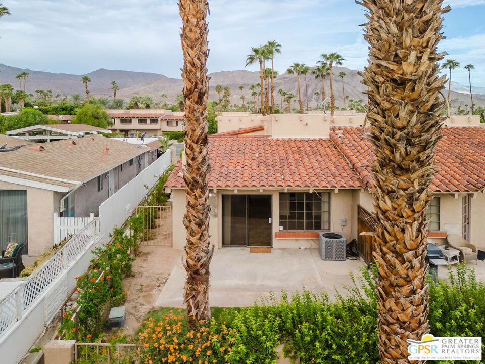 46400 Ryway Place, Unit 10 Palm Desert, CA 92260 - Photo 21 of 48 a front view of a house with a garden and sitting area