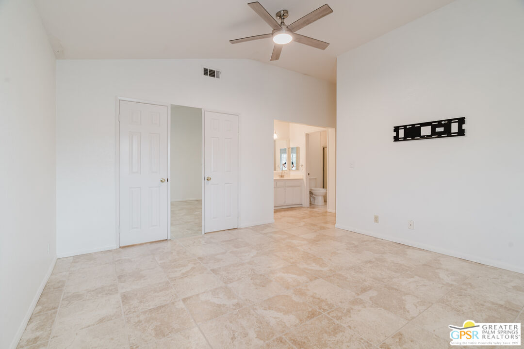 46400 Ryway Place, Unit 10 Palm Desert, CA 92260 - Photo 32 of 48 an empty room with fan and entrance