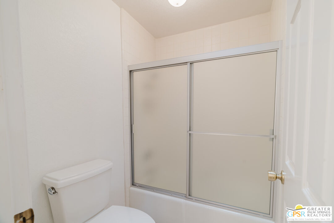 46400 Ryway Place, Unit 10 Palm Desert, CA 92260 - Photo 33 of 48 a bathroom with a shower a toilet and a sink