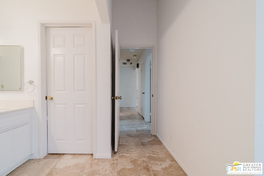 46400 Ryway Place, Unit 10 Palm Desert, CA 92260 - Photo 34 of 48 a view of a hallway with closet and wooden floor