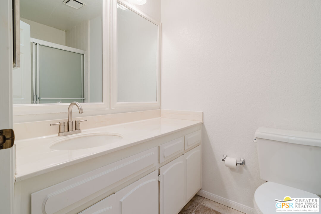 46400 Ryway Place, Unit 10 Palm Desert, CA 92260 - Photo 36 of 48 a bathroom with a sink a toilet and a mirror