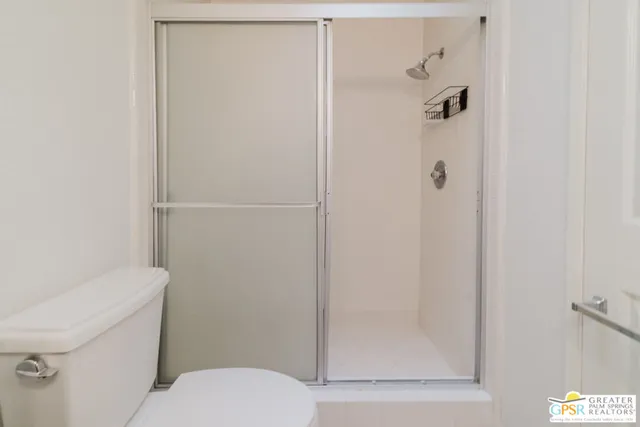 a white toilet sitting next to a bathroom sink