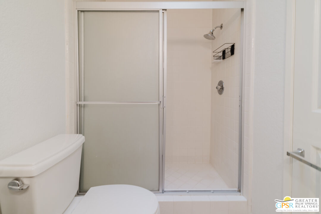 46400 Ryway Place, Unit 10 Palm Desert, CA 92260 - Photo 37 of 48 a white toilet sitting next to a bathroom sink