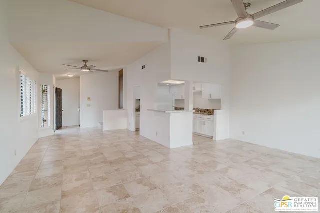 a view of kitchen with stainless steel appliances cabinets a sink and a refrigerator